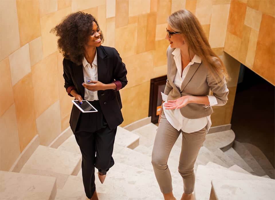 two women walking up stairs